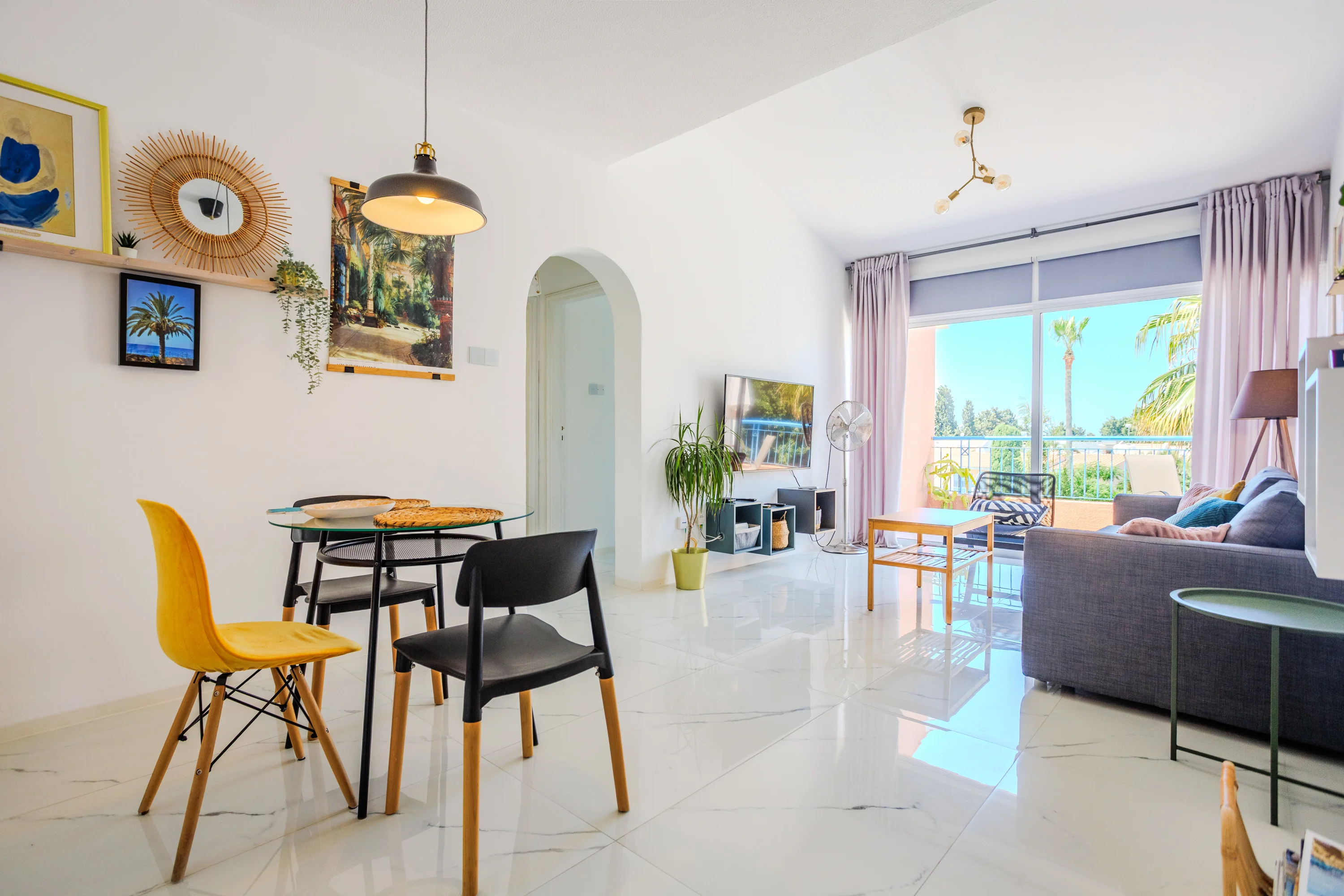 Open-plan living and dining area with balcony doors