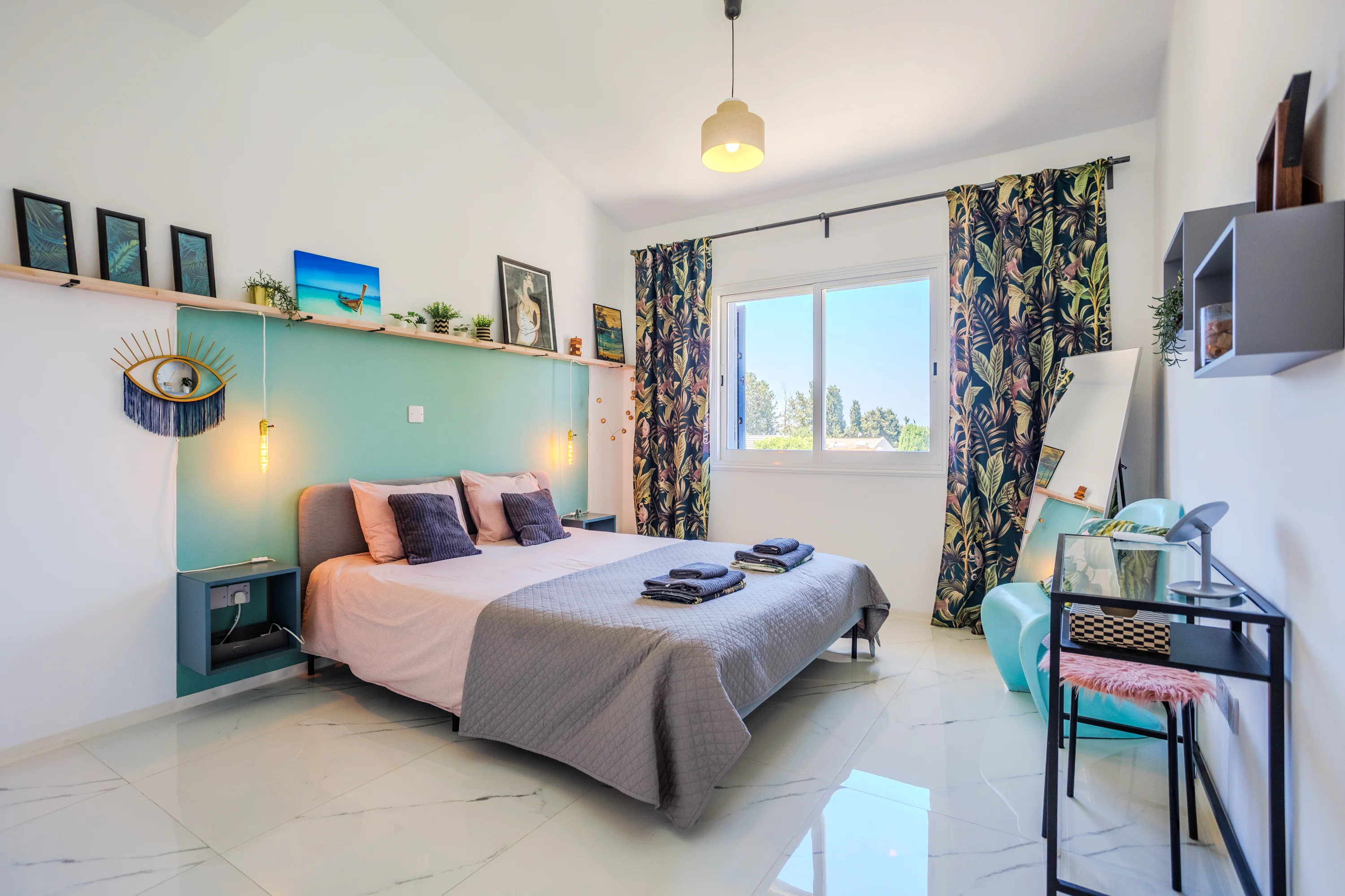 Bedroom with double bed and mint feature wall