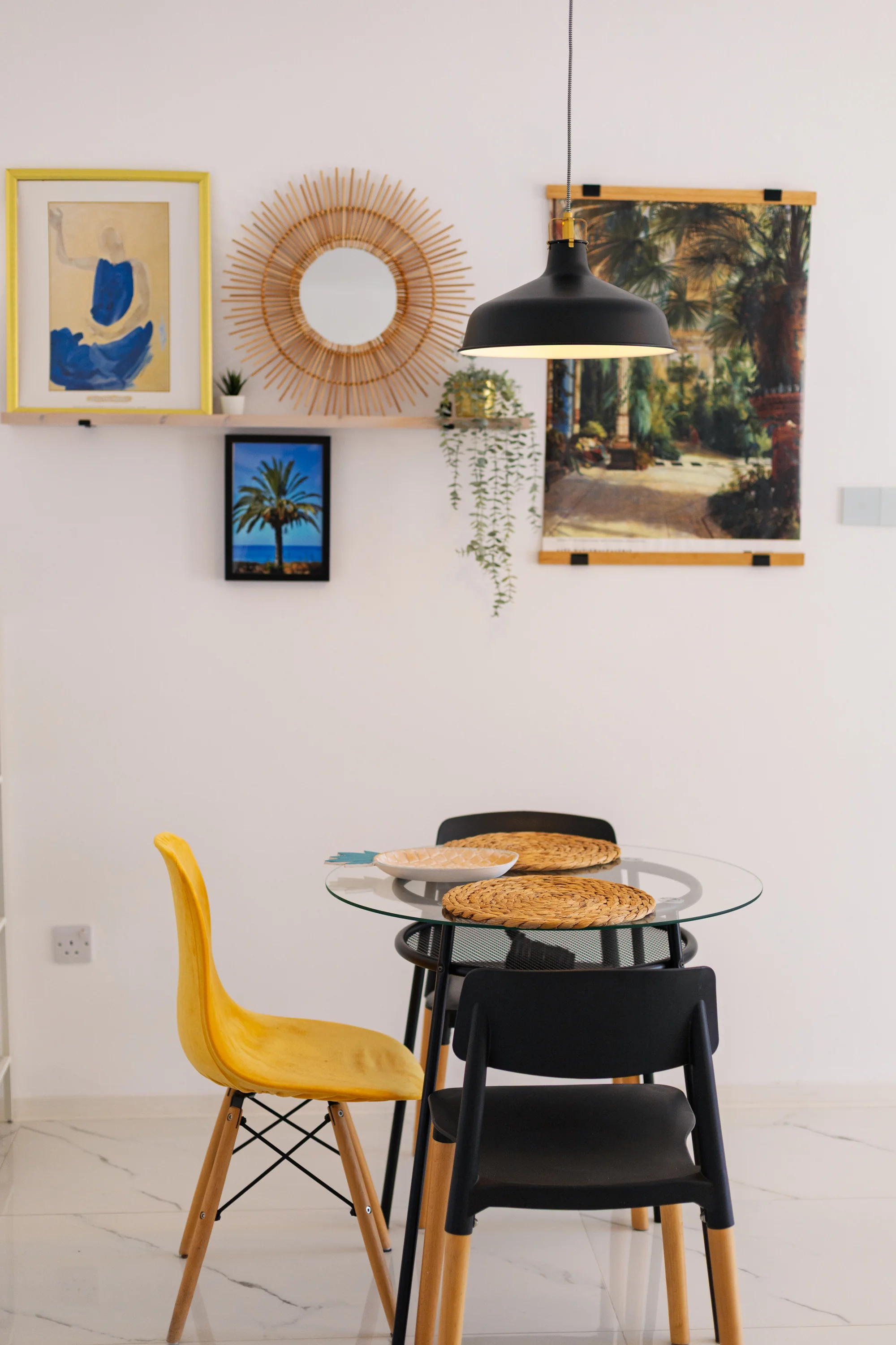 Dining table for two beneath the gallery wall