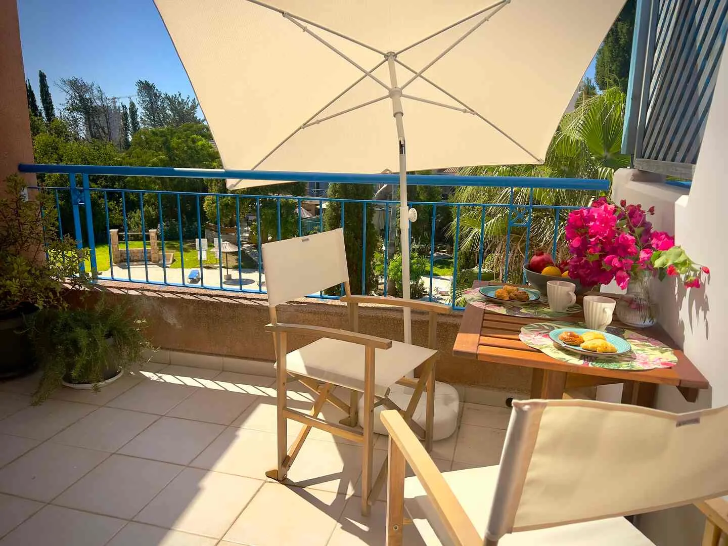 Balcony table set for breakfast overlooking the gardens
