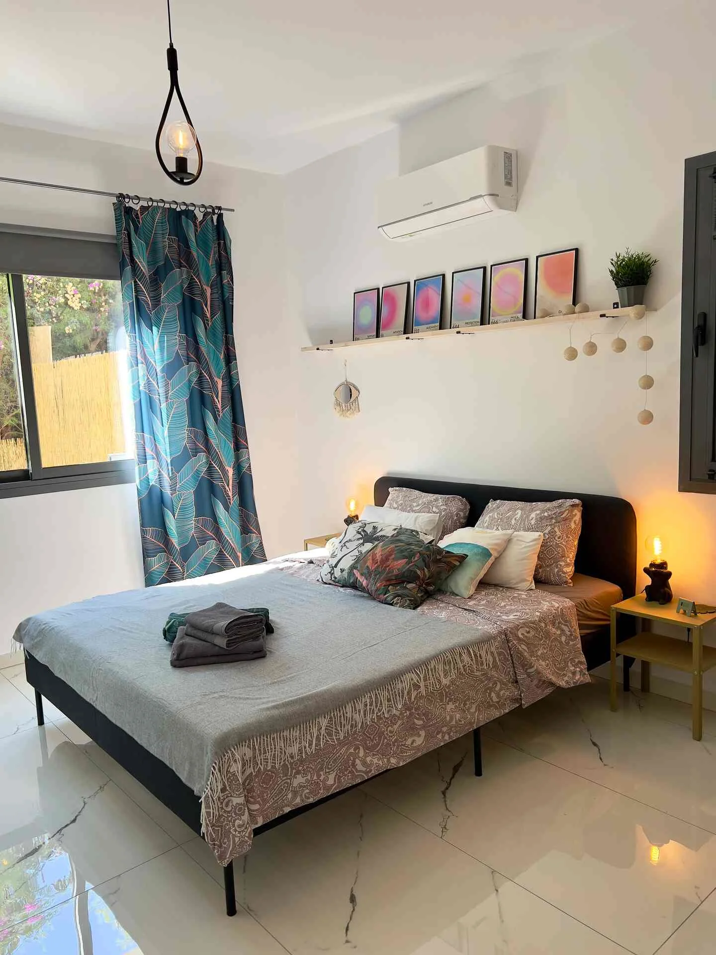 Bedroom with double bed and tropical curtains