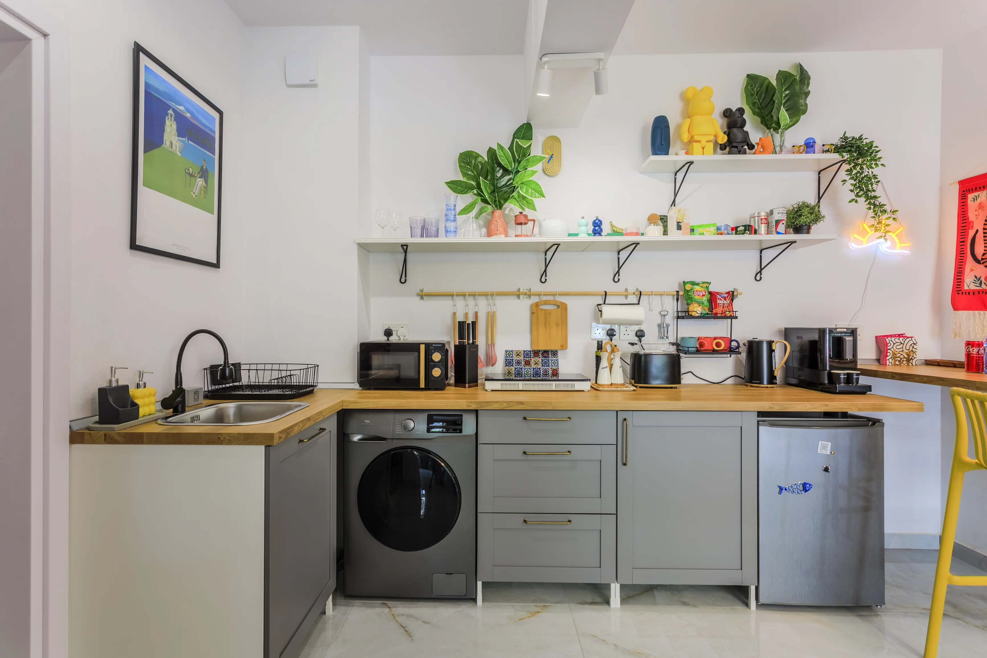 Kitchen with washing machine, oven and fridge