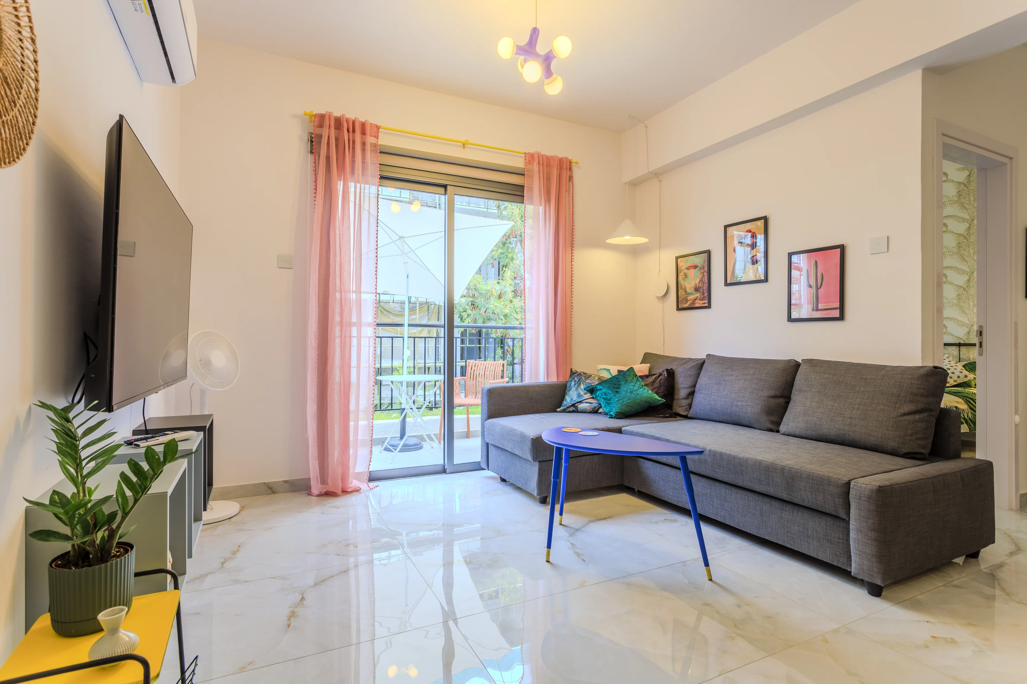 Living room of Margarita Gardens 2 with balcony doors open