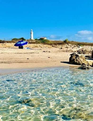 Clear shallow water and the lighthouse at Lighthouse Beach