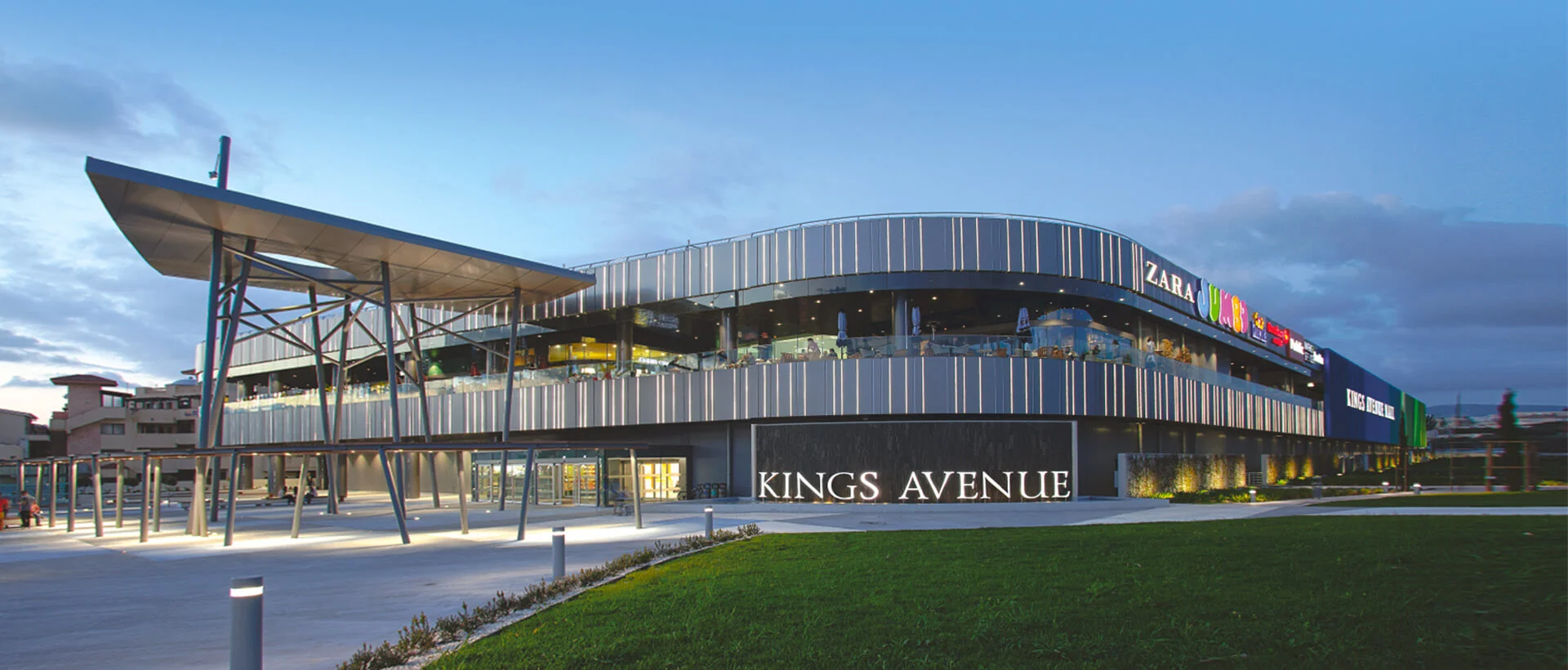 Kings Avenue Mall lit up at dusk